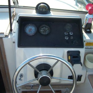 The helm.  Black bracket to right of wheel is for a Humminbird "Wide Onehundred" which was included.