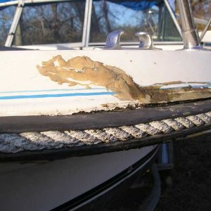 (1) When I first saw the boat, this badly repaired "dock bang" seemed the worst thing as far as fiberglass damage.  But once I got the rubrail off it 