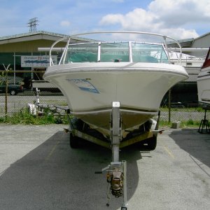 Before - Head On. The plan is to strip(the boat!), paint, new seats, refinish teak, new rub rail and hardware. Trailer work next year.