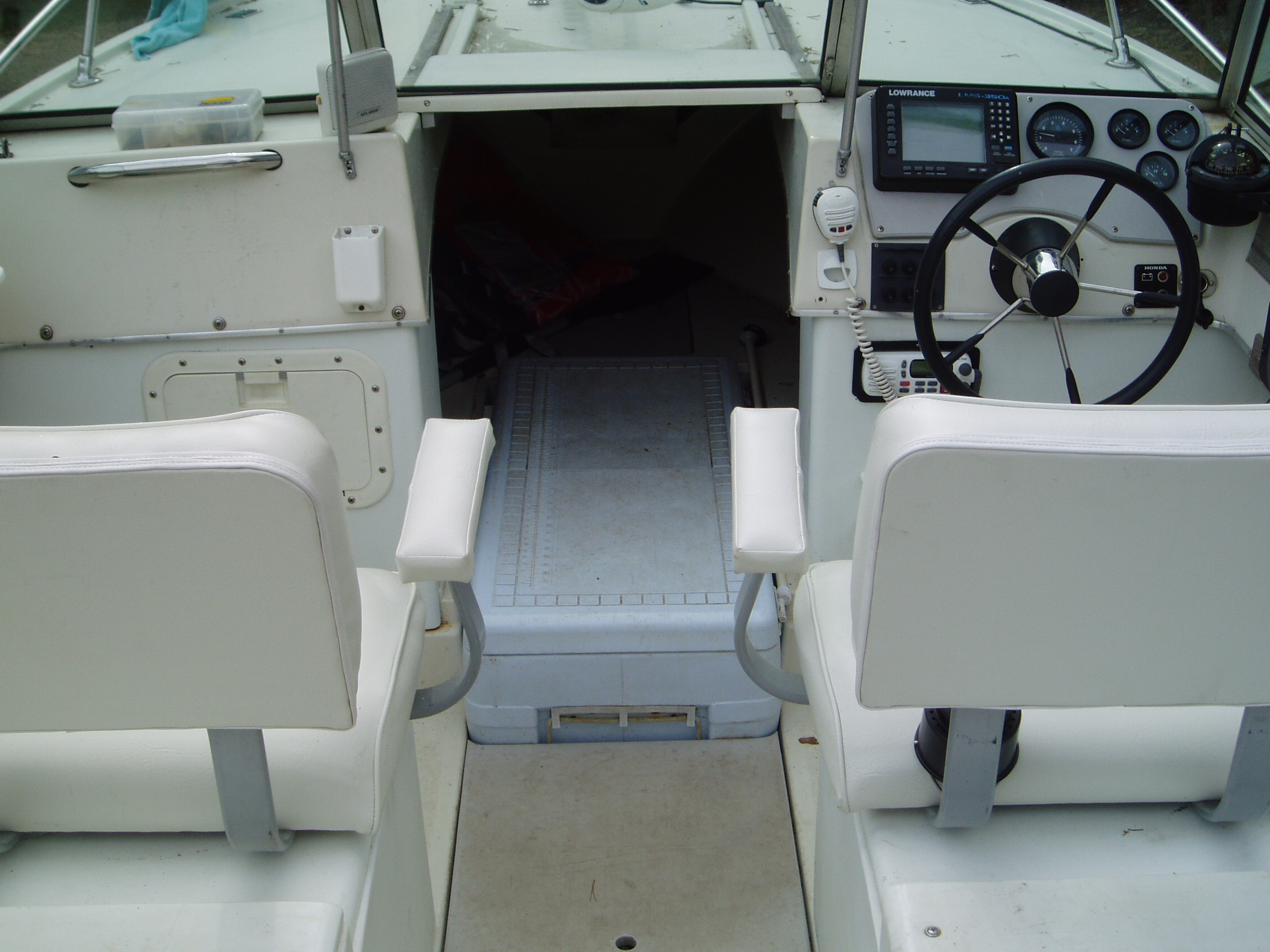 2 Fat-Boy swivel seats...120 quart cooler in front hatch is fish-box...custom-cut 3/4" Starboard lid covers remaining hatch for more storage...