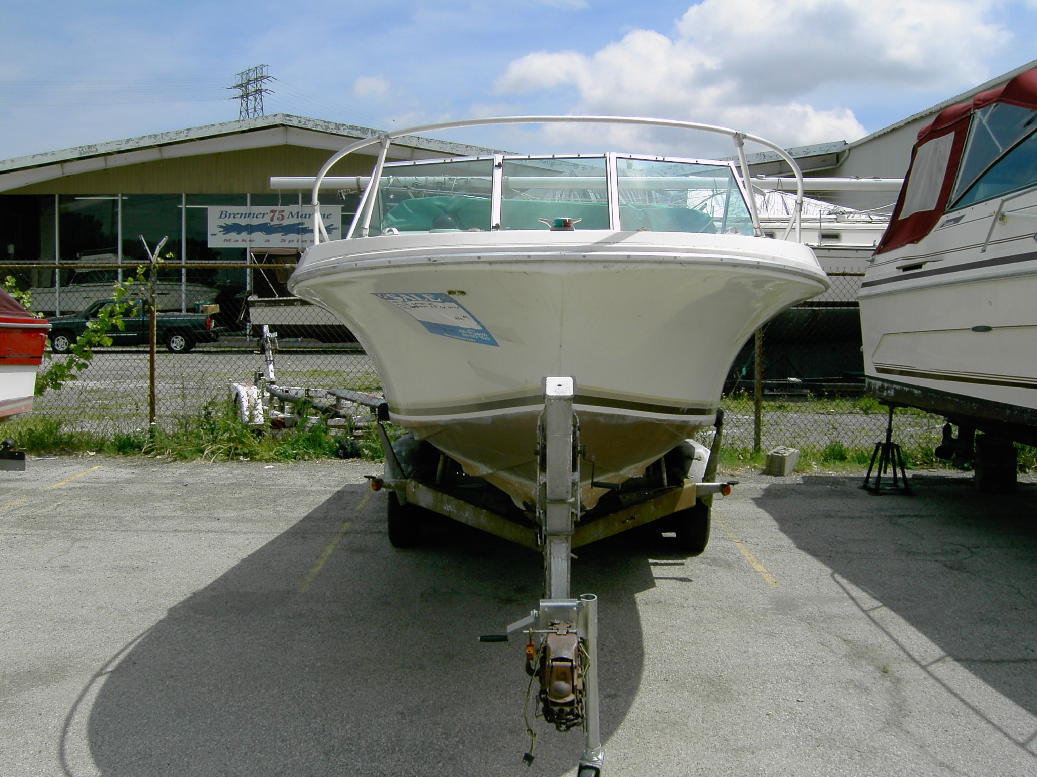 Before - Head On. The plan is to strip(the boat!), paint, new seats, refinish teak, new rub rail and hardware. Trailer work next year.