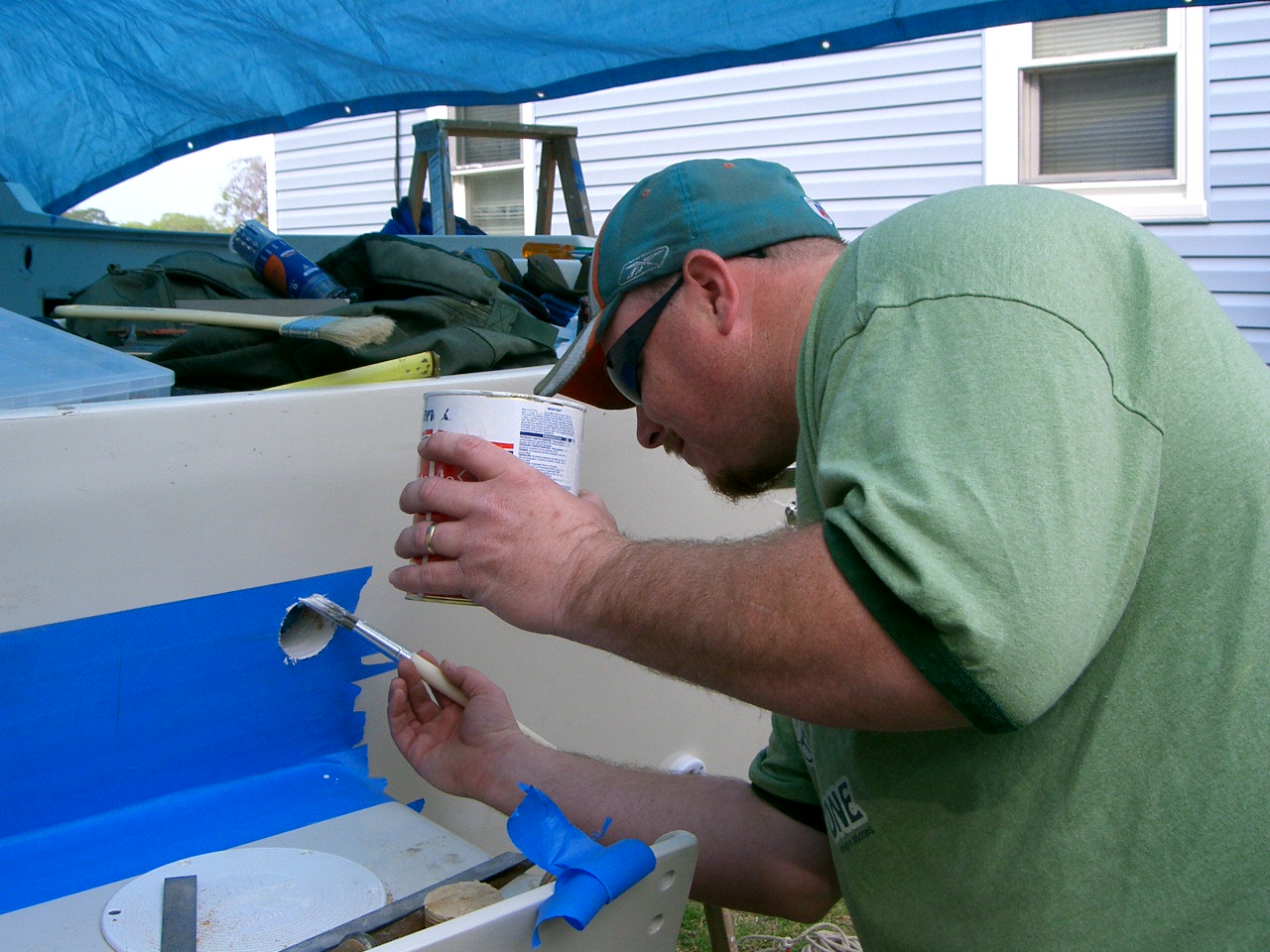 My son painting newly exposed wood