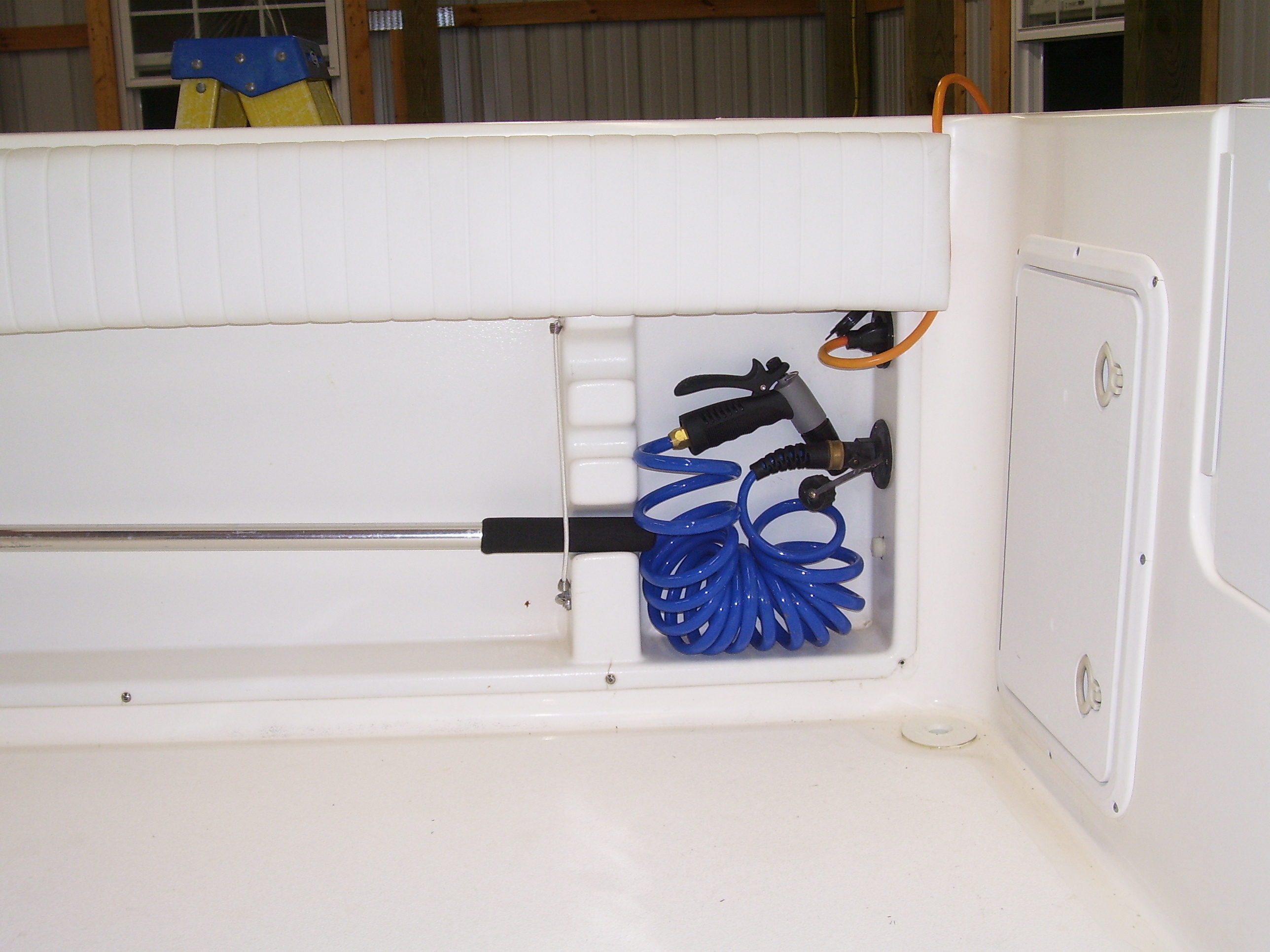 Stbd side aft, washdown hose & battery charger waterproof outlet.